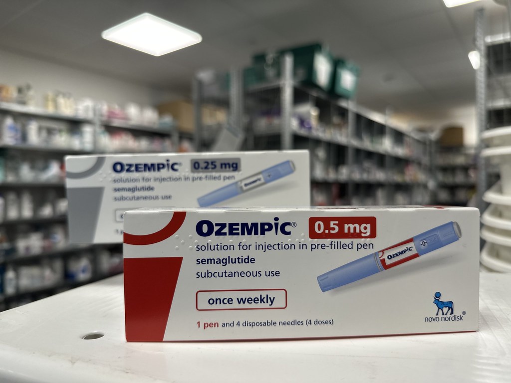 A box of Ozempic (Semaglutide) in front of a pharmacy