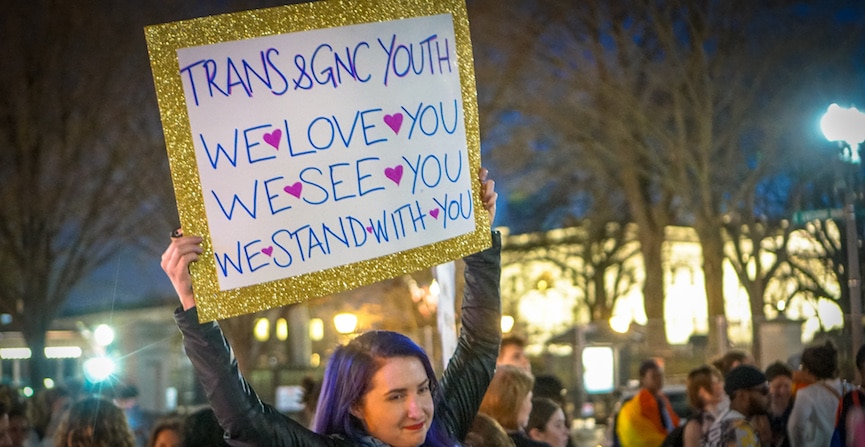 Dance Protest Celebrating Trans Youth, The White House, Washington, DC USA, woman holding a sign saying "Trans and Gender Non-Conforming Youth, We Love You, We See You, We Stand With You."