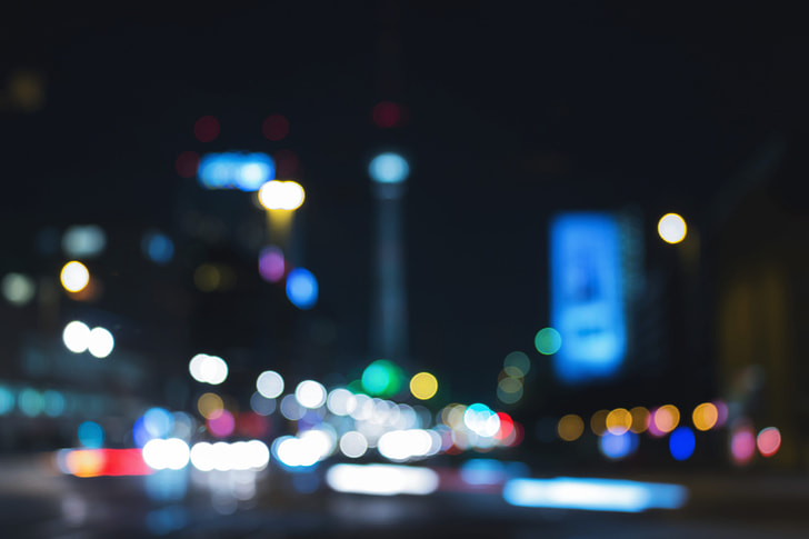 a blurry photo of mostly blue city lights from street level at night