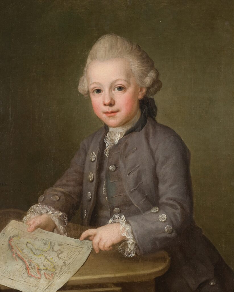 Portrait of a young boy in 18th-century attire, sitting at a small table while holding a map. He is wearing a formal, buttoned jacket with lace cuffs and has a gentle expression, with his hair styled in a traditional fashion of the era. The painting has a warm, classical tone, and the boy appears to be looking directly at the viewer.